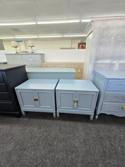 Pair of blue nightstands with doors